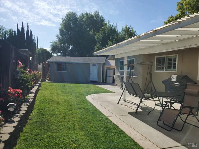 a view of a backyard with sitting area