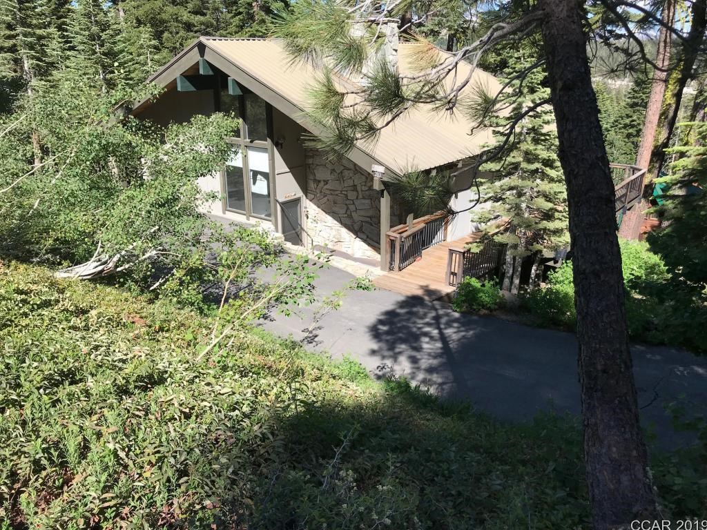 a view of a house with a small yard