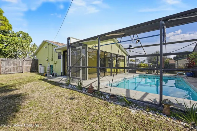 a view of a house with backyard and sitting area