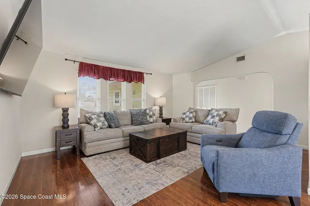 a living room with furniture and a rug