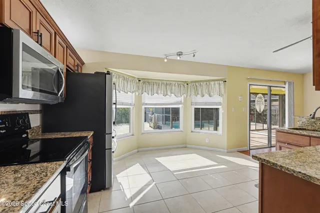 a kitchen with stainless steel appliances granite countertop a stove and a sink