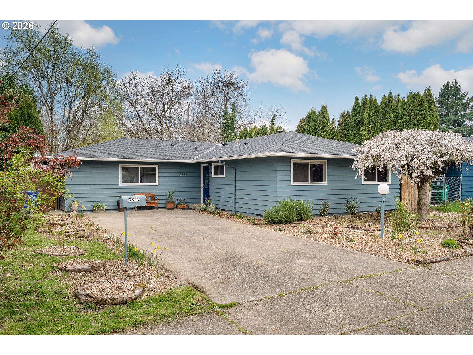 3835 North Alaska Street Portland, OR 97217 - Photo 1 of 43 a backyard of a house with table and chairs under an umbrella