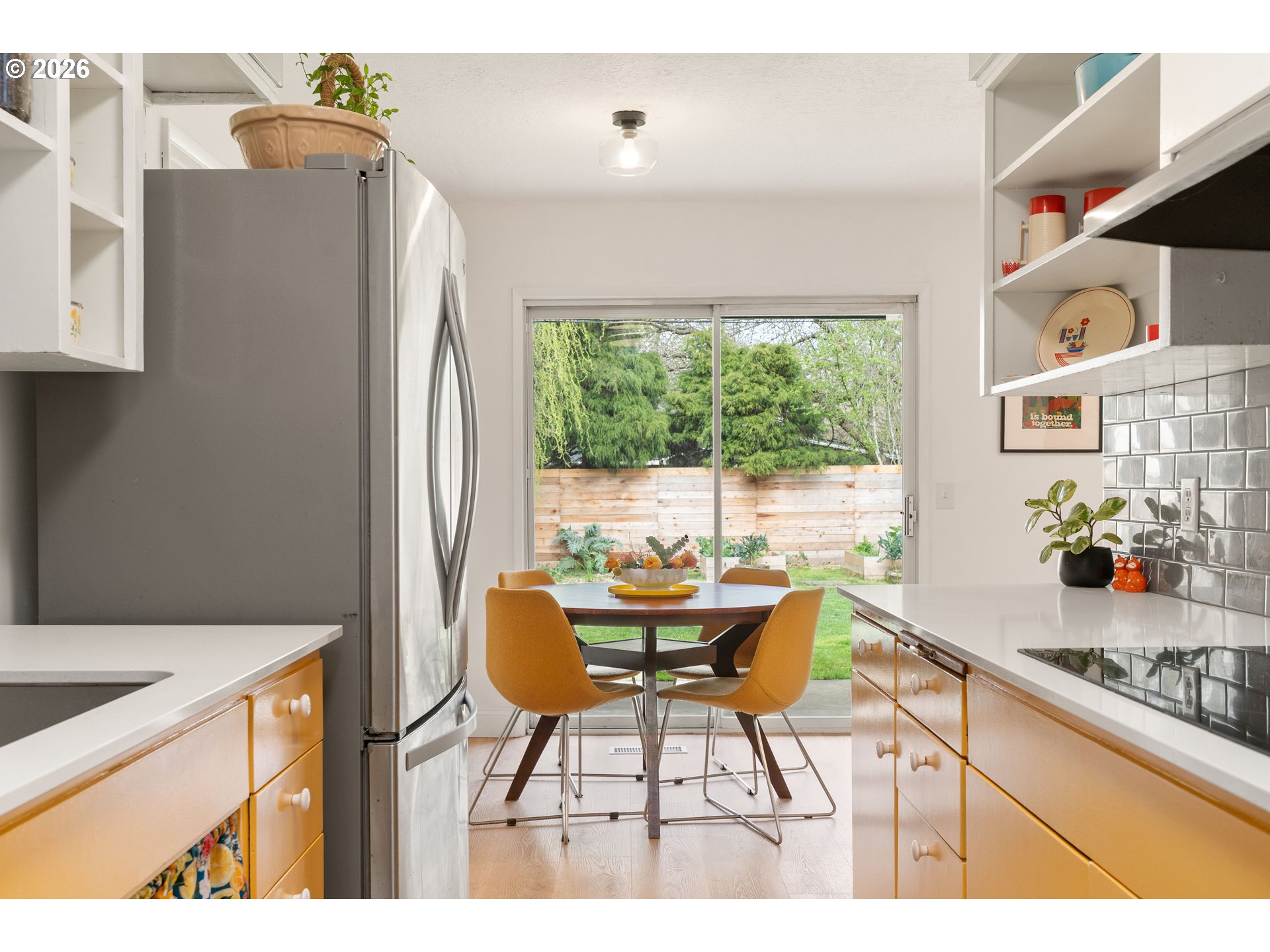 3835 North Alaska Street Portland, OR 97217 - Photo 12 of 43 a kitchen with a table and a refrigerator