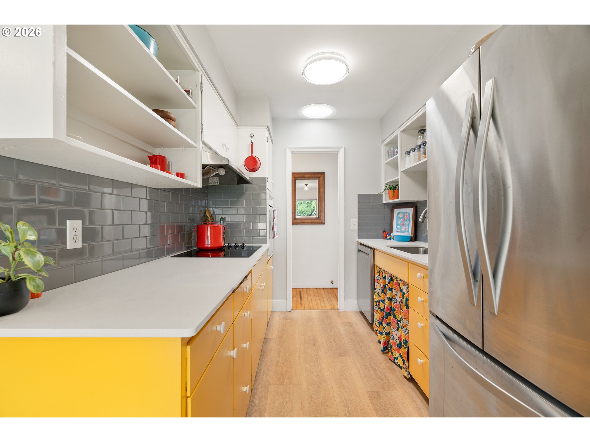 3835 North Alaska Street Portland, OR 97217 - Photo 14 of 43 a kitchen view with stainless steel appliances a refrigerator and a wooden floor