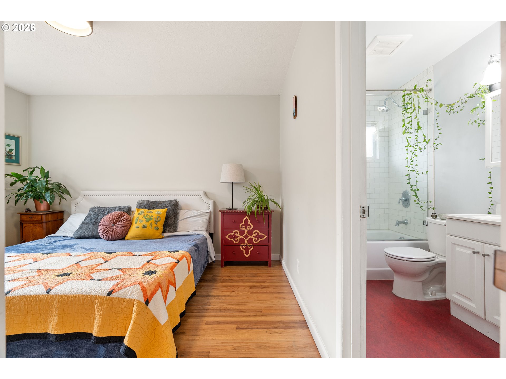 3835 North Alaska Street Portland, OR 97217 - Photo 20 of 43 a bedroom with a bed and a potted plant