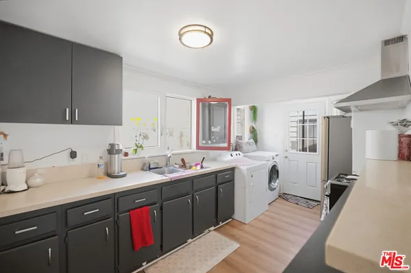 a kitchen with a sink stove and cabinets