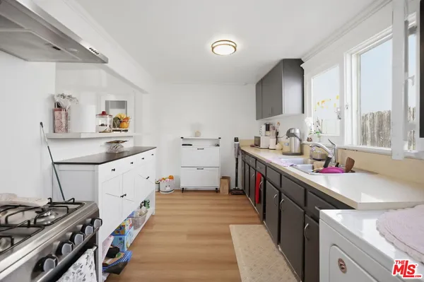 a kitchen that has a sink and a stove in it