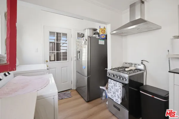 a kitchen with a refrigerator stove and sink