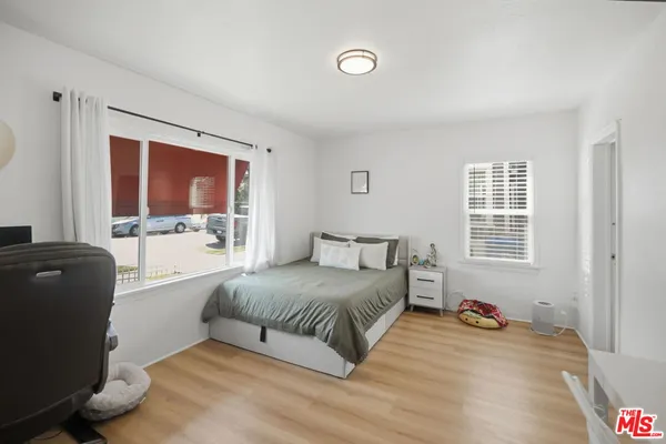 a living room with a bed furniture and a window