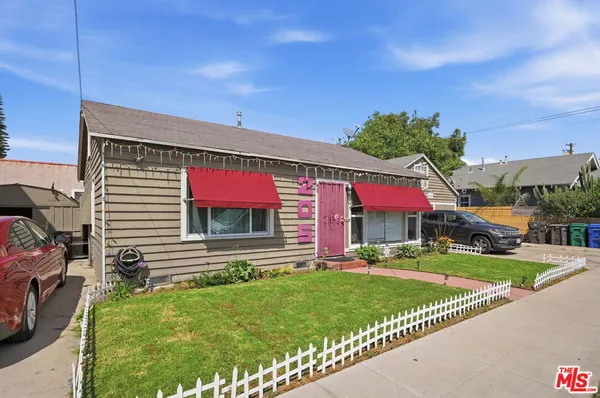 a front view of a house with a yard table and chairs