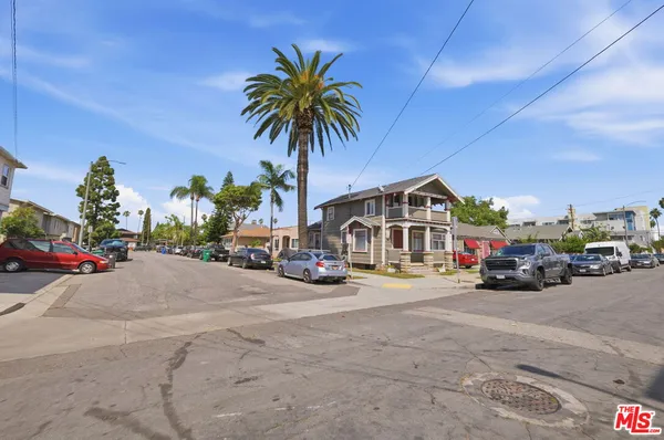 a view of a street with a car parked in front of it