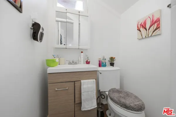a bathroom with a sink vanity and toilet