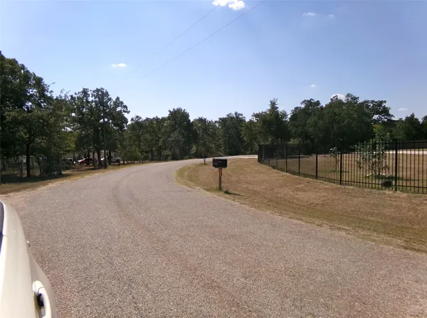 a view of a house with garden and trees