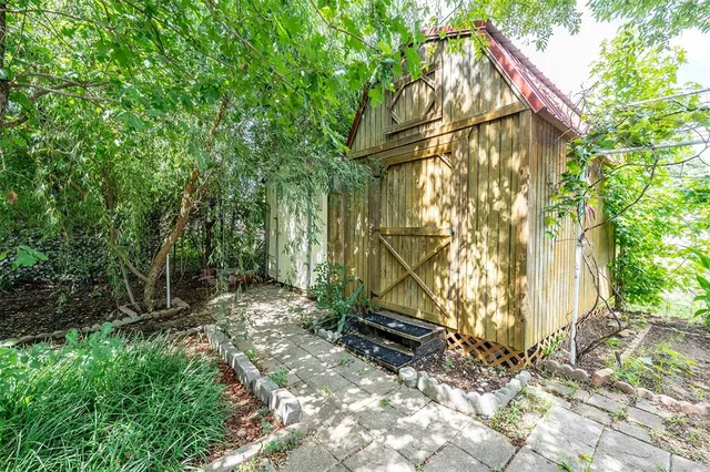 a backyard of a house with lots of green space and wooden fence