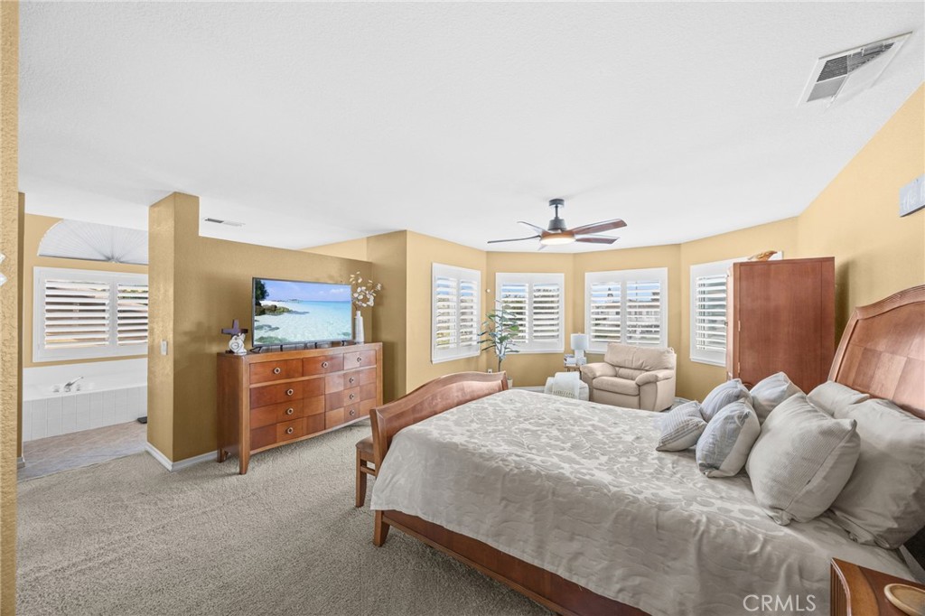 20257 Edmund Road Riverside, CA 92508 - Photo 26 of 53 a bedroom with a bed and a chandelier