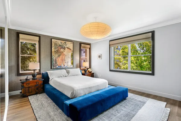 a bedroom with a large bed and a large window