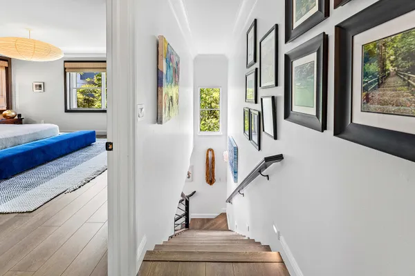 a bedroom with furniture and a large window