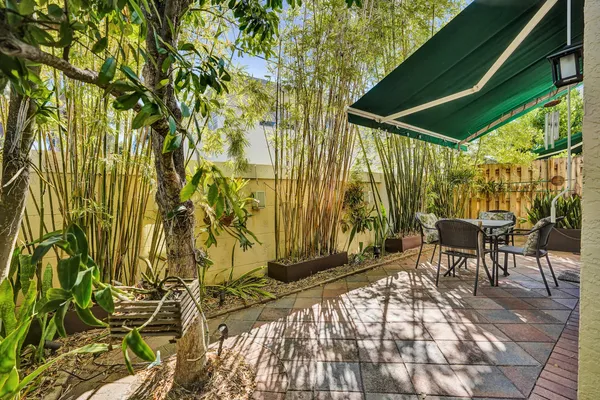 a backyard of a house with table and chairs