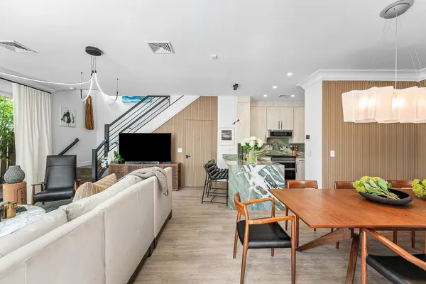 a living room with furniture a flat screen tv and a large window
