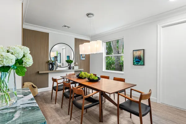 a view of a dining room with furniture window and wooden floor
