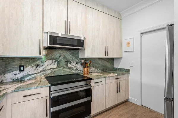 a kitchen with granite countertop a stove and a sink