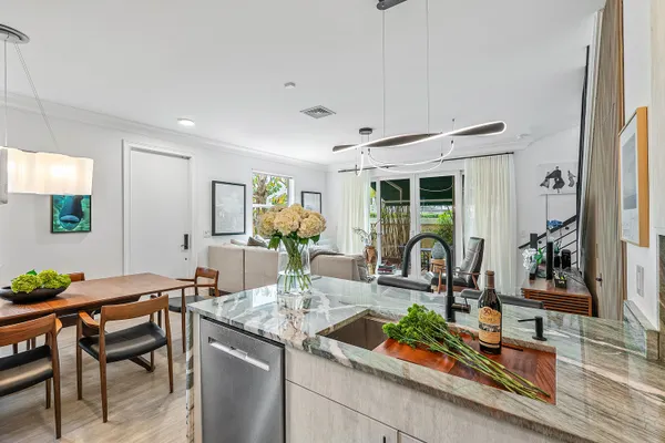 a living room with furniture a flat screen tv and a large window