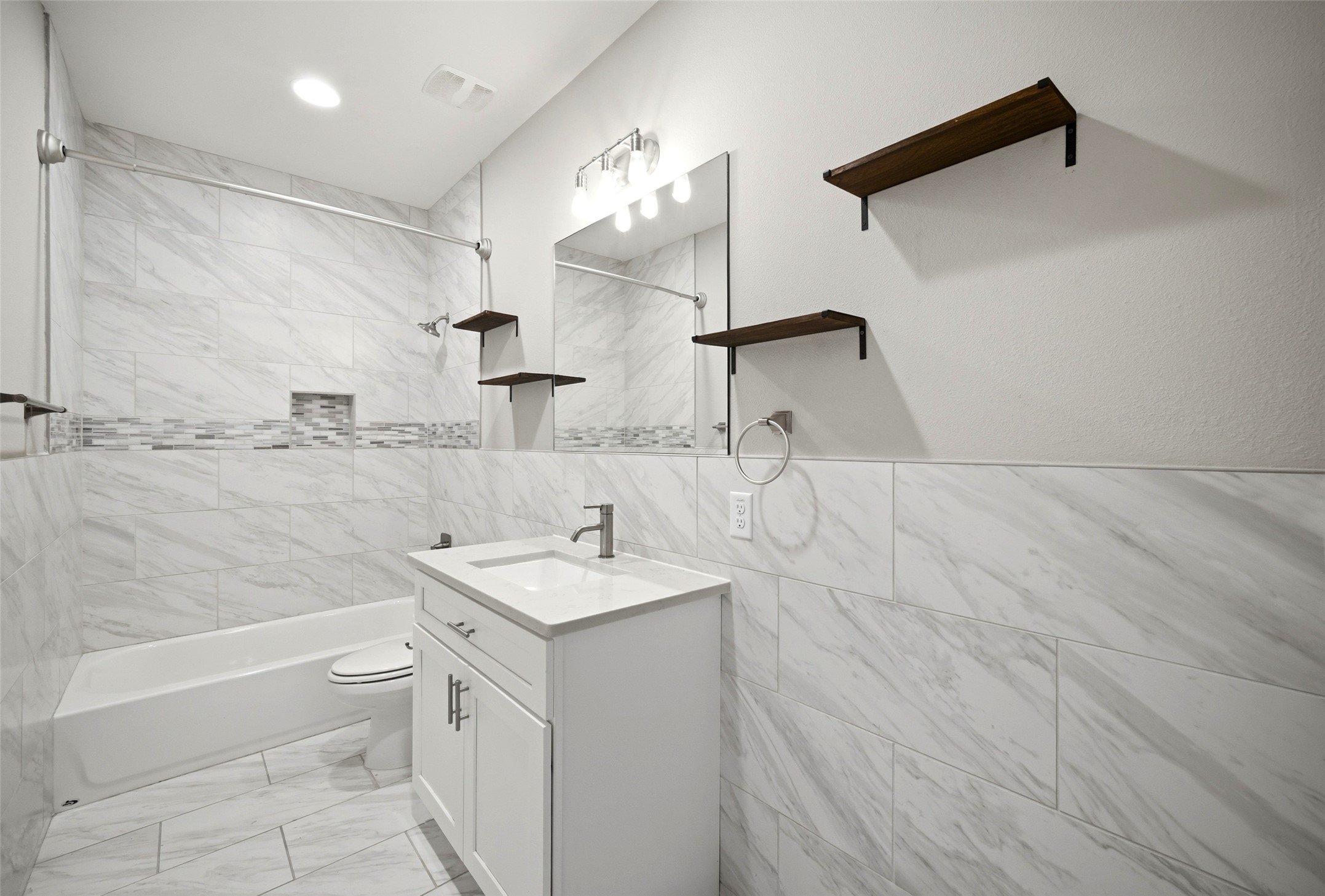 605 Dumble Street Houston, TX 77023 - Photo 40 of 44 a bathroom with a sink a toilet and a large mirror