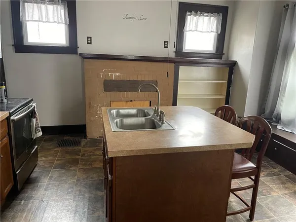 a kitchen with a sink a stove and cabinets