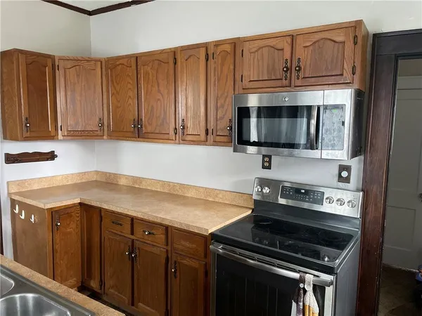 a kitchen with granite countertop a stove and a microwave