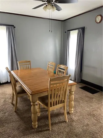 a view of a dining room with furniture and a chandelier