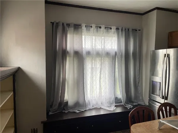 a view of a mirror and a bathroom with a sink