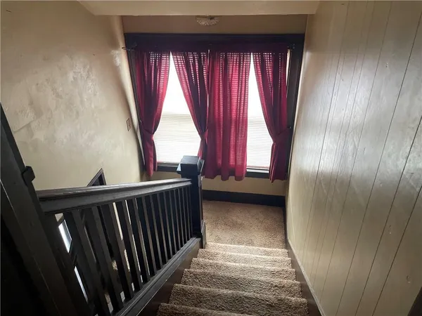 a view of a room with wooden floor and windows