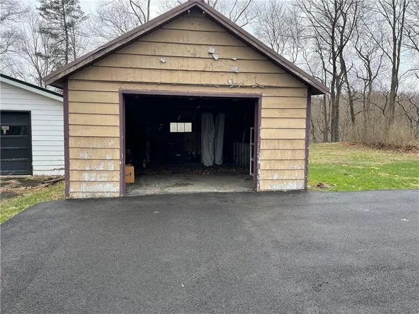 a view of a house with a yard and garage