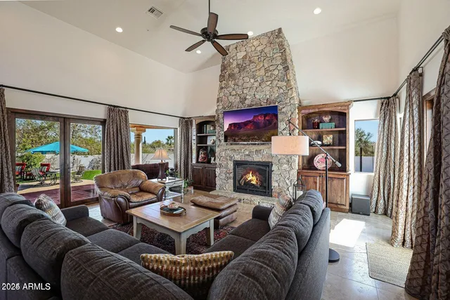 a living room with furniture large window and a flat screen tv