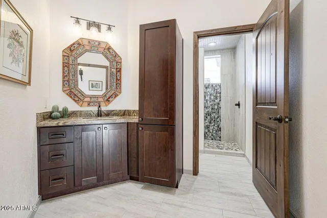 a bedroom with a large bed and a chandelier