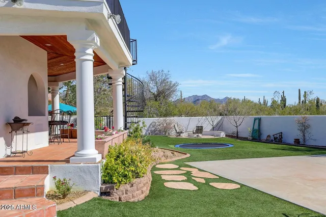 a living room with patio furniture and a floor to ceiling window
