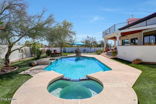 a view of a backyard with a patio and fire pit