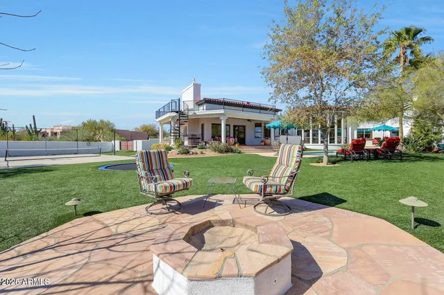 a view of a big yard with a table and chairs