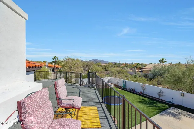 a backyard of a house with table and chairs