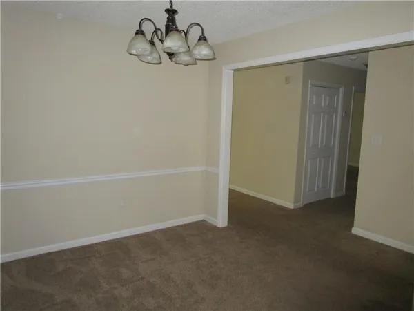 a view of empty room with a fireplace