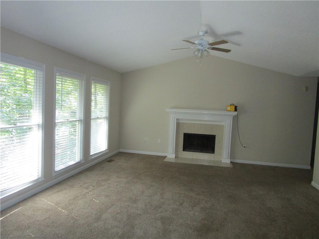 2429 Thompson Mill Road Gainesville, GA 30506 - Photo 14 of 52 a view of an empty room with a fireplace and a window