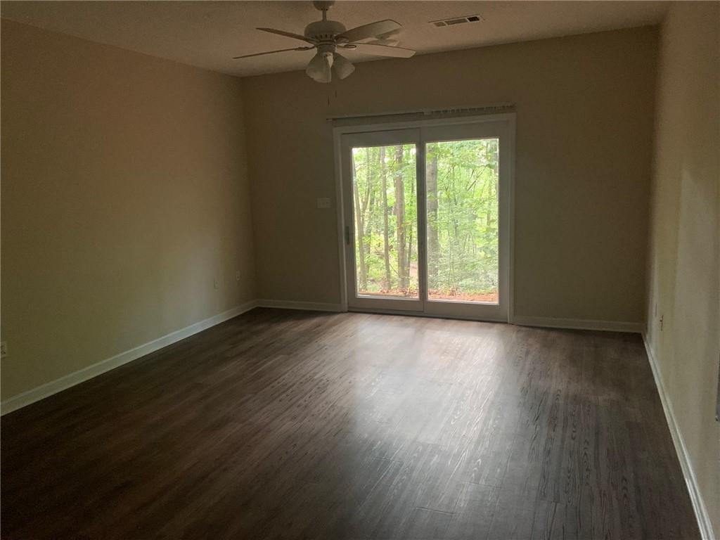 2429 Thompson Mill Road Gainesville, GA 30506 - Photo 29 of 52 a view of an empty room with wooden floor and a window