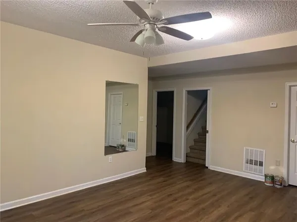 a view of a small space with wooden floor and a window