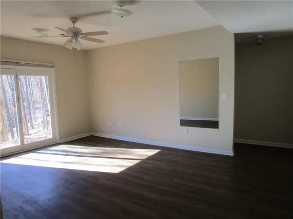 an empty room with wooden floor and closet