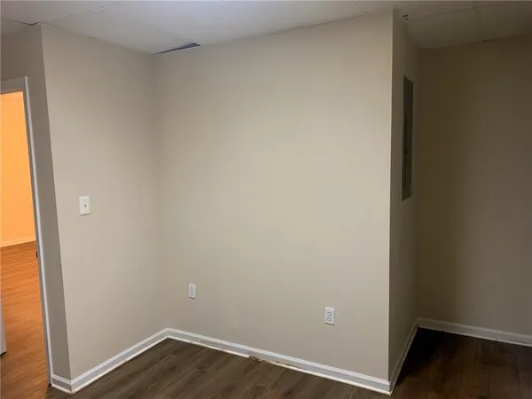 a view of a patio with a table and chairs under an umbrella