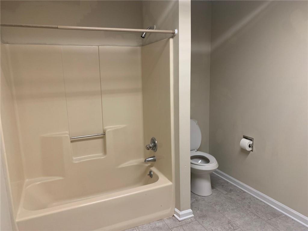 2429 Thompson Mill Road Gainesville, GA 30506 - Photo 40 of 52 a bathroom with a bathtub and a toilet