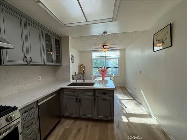 a kitchen with a sink cabinets and wooden floor
