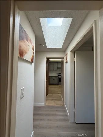 a view of a hallway with wooden floor