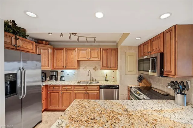 a kitchen with a sink stove and refrigerator
