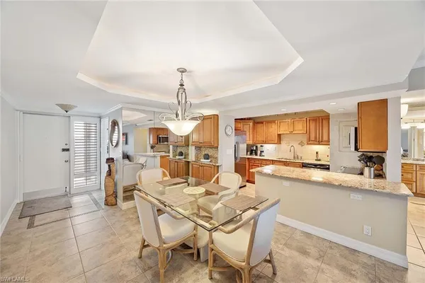 a dining hall with stainless steel appliances a table and chairs with wooden floor